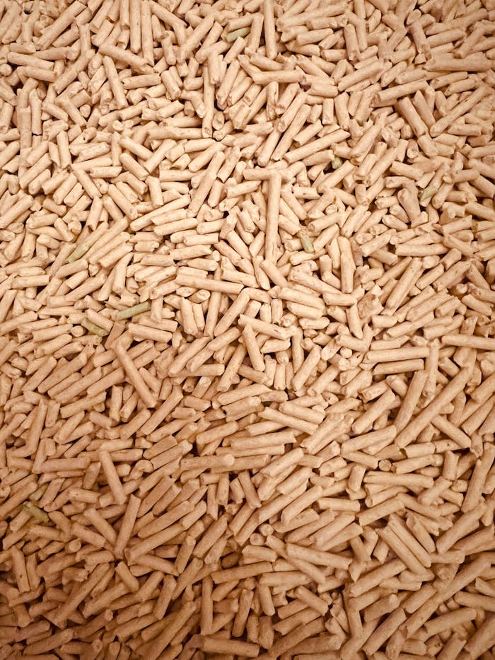 about-us A detailed top view of a large pile of wood pellets used for renewable fuel and energy.